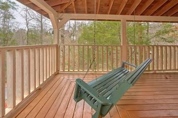 Cabin In The Woods Porch Swing Rock away to a relaxing book or music surrounded by nature.